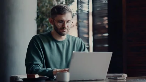IT Professional Working Remotely With Laptop From Cafe, Freelancer Programmer 動画素材 343669158