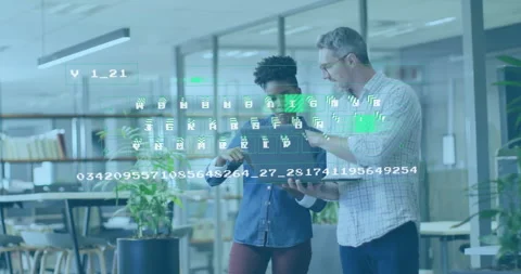 IT professionals examining laptop making code overlay appear, tapping blocks Stock Footage 310419224