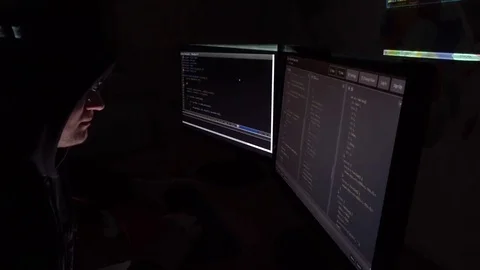 IT programmer in glasses working at the computers in dark room Stock Footage 73456238