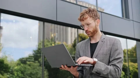 IT programmer holds a laptop in his hands, writes program code, works remotely. Video stock 222768945