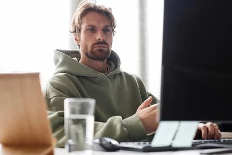 IT Programmer Looking at Computer Screen Working in Office Stock Photos
