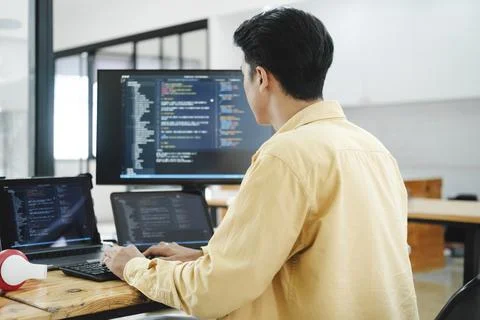IT Programmer Starts Working on Desktop Computer. Stock Photos