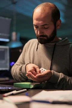 IT programmer taking medicine pills from box Stock Photos
