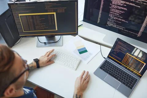 IT Programmer Using Computers with Code on Screen Stock Photos