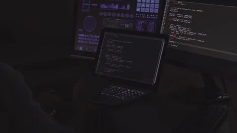 IT programmer is working on laptop in dark room Stock Footage 73455411