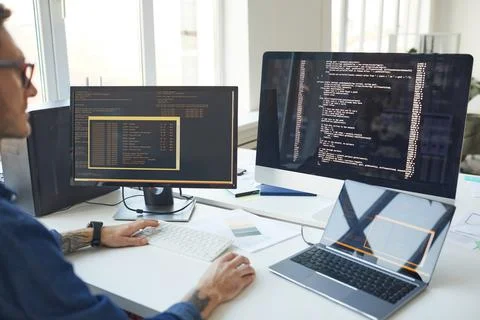 IT Programmer Writing Code on Computer Screen Stock Photos