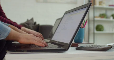 IT programmers typing lines of HTML code on laptops Stock Footage 100633450