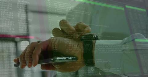IT pro's hand pointing stylus at tablet in IT office, with smartwatch and Stock Photos