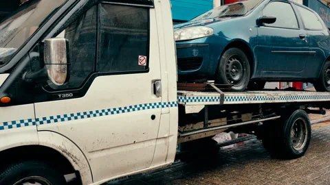 It is raining. Crashed car in a tow truck. Stock Footage 86814730