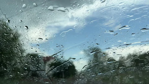 It is raining on the glass, a drop of water flow down the glass Stock Footage 196875072