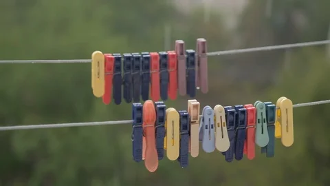 It is raining outside. Clothes are pinned on a bandage, swaying in the wind. Stock Footage 129892272