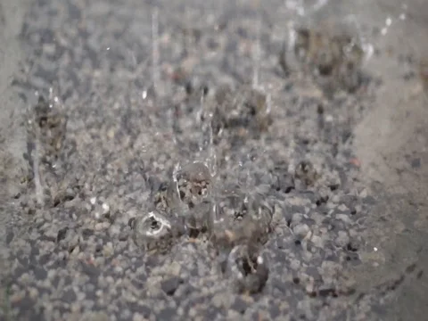 It is raining outside. Rain drops break in a puddle. Close up. Stock Footage 92652248