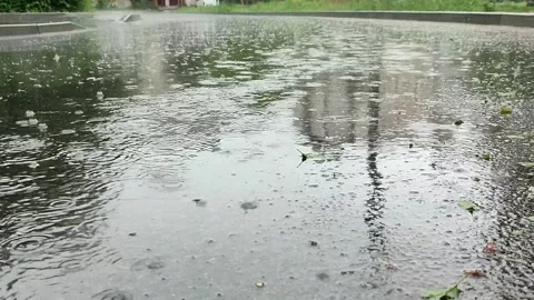 It is raining outside. Rain drops break in puddle. Slow motion 動画素材 154904797