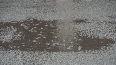 It rains and forms bubbles on water.Puddles in pits in asphalt road. Stock Footage 107726464