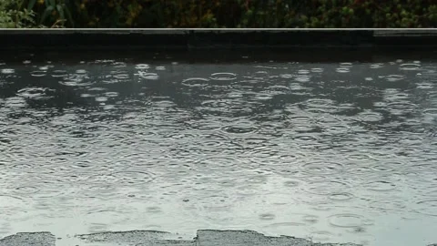 It s raining on a black flat roof Stock Footage 154482024