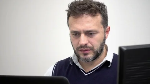 IT security technician, caucasian man employee working in office on a computer Stockbeeldmateriaal 81779076