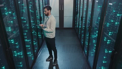 IT server administrator working in data center inspecting computer rack server Video stock 119231829