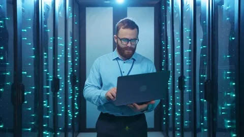 IT server engineer working on laptop experiencing failure blackout at data Stock Footage 120794757