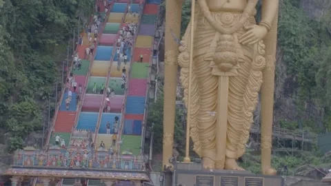 It showcases the towering statue at Batu Caves. Video stock 341833319
