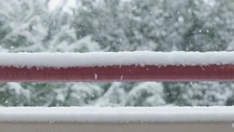 It is snowing on balcony's wall and railing Stock Footage 149298229