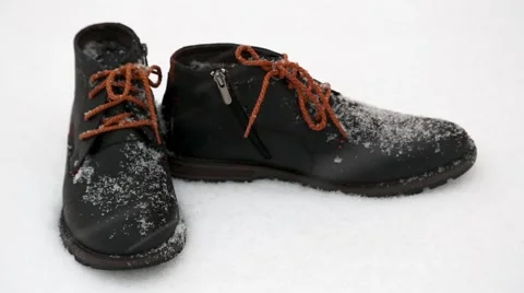 It is snowing - new winter boots standing in the snow 스톡 동영상 58411571