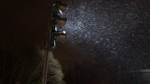 It is snowing the searchlight is shining Stock Footage 100773973