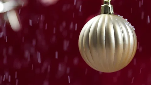 It snows on the gold ball decor. Red New Year and Christmas background. Stock Footage 145331270