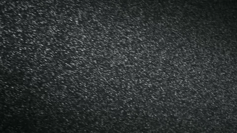 It snows at night in a ray of light. Stock Footage 148780036