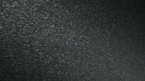 It snows at night in a ray of light. Stock Footage 156955936