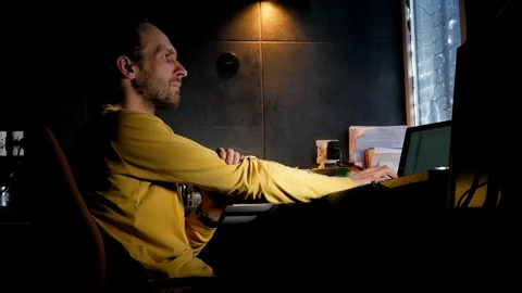 IT software developer bearded man sits at dark room and thinking about code  Stock Footage 105336700