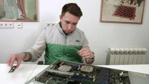 IT Specialist changing components on the motherboard of the server Stock Footage 75679449