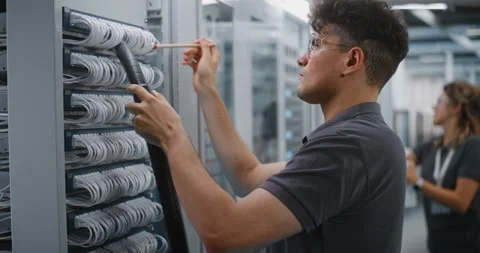 IT Specialist Cleaning Server Cables with Vacuum Hose and Brush Stock Footage 344889822