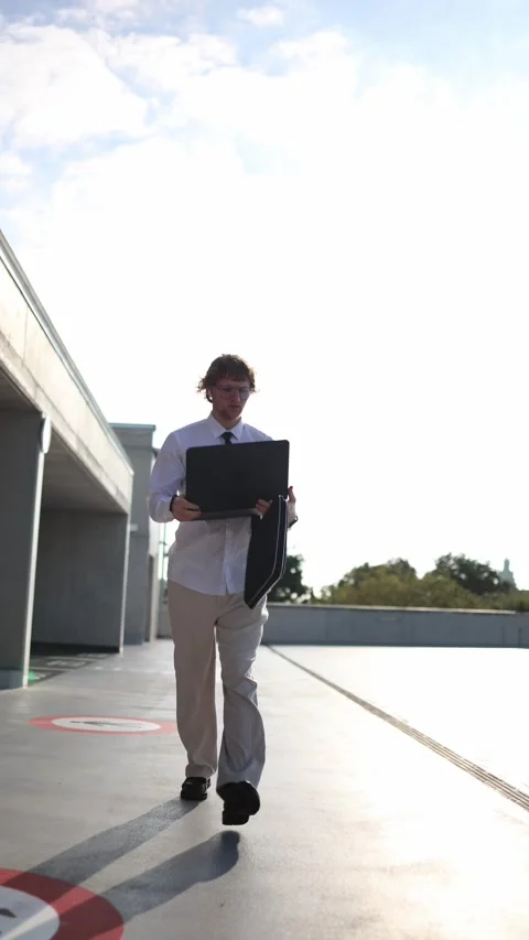 IT specialist codes on laptop while walking during everyday activities Stock-Footage 345992812