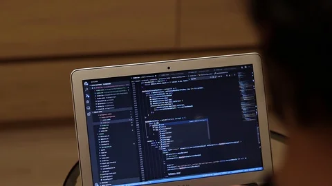 IT Specialist coding on laptop, view from the back. Real programming footage Stock Footage 121581352