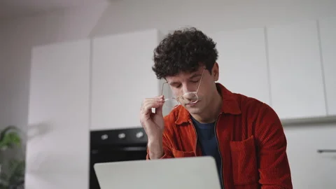 IT specialist experiencing eye strain while working at home, taking off glasses Stock Footage 337907317