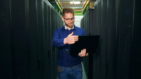 IT specialist in glasses is smiling at camera Stock Footage 115660175