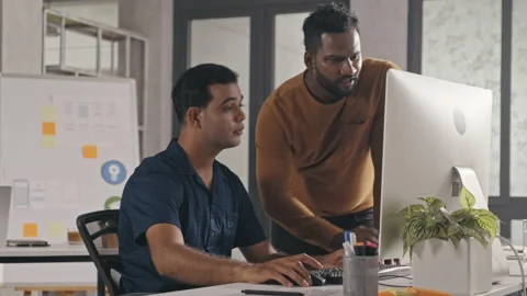 IT Specialist Helping Colleague at Work in Office Stock Footage 232419849
