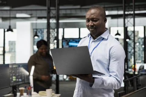 IT specialist in office automating using artificial intelligence on laptop Stock Photos