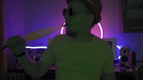 IT specialist smoking hookah while working remotely from home during quarantine Stock Footage 130043595