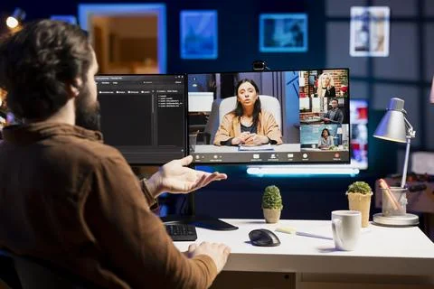 IT specialist teaching trainees in videoconference how to fix coding mistakes 写真素材
