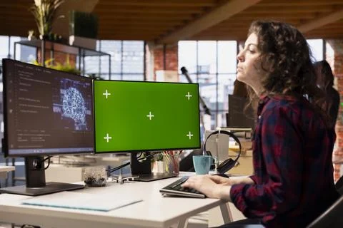 IT specialist in tech startup using AI machine learning systems on chroma key PC Stock Photos