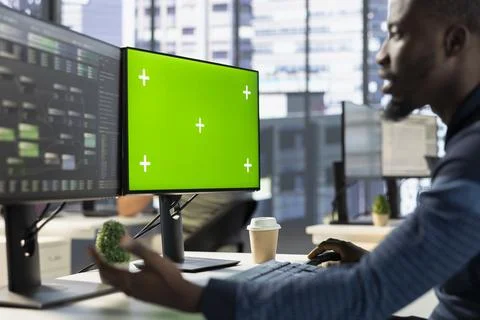 IT specialist training predictive models using green screen computer Foto stock