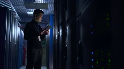 IT specialist using device and doing network diagnostics while standing on Stock Footage 163784684