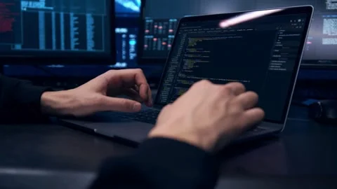 IT specialist work in laptop screens of codes and program software. Side view of Stock Footage 334585832