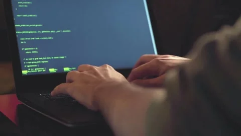 IT specialist work in laptop screens of codes and program software. Side view of 库存影片 334586639