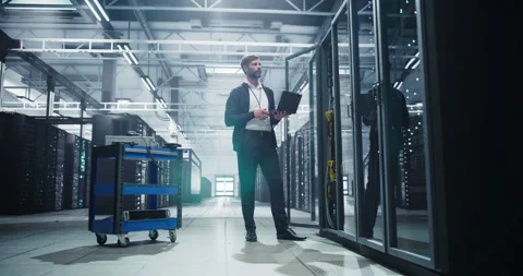 IT Specialist Working on Laptop in Data Center Stock Footage 320866140