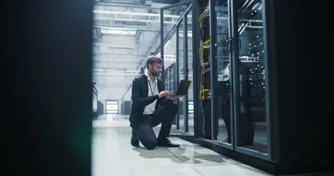 IT Specialist Working on Laptop in Data Center Stock Footage 320866193
