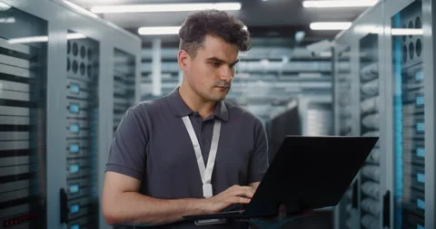 IT Specialist Working on Laptop in Data Center Server Room Stock Footage 344879898