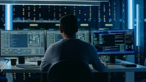 IT Specialist Working on Personal Computer with Monitors Showing Coding Language Stock Footage 103512473
