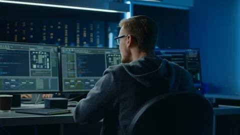 IT Specialist Working on Personal Computer with Monitors Showing Coding Language Stock Footage 103513774